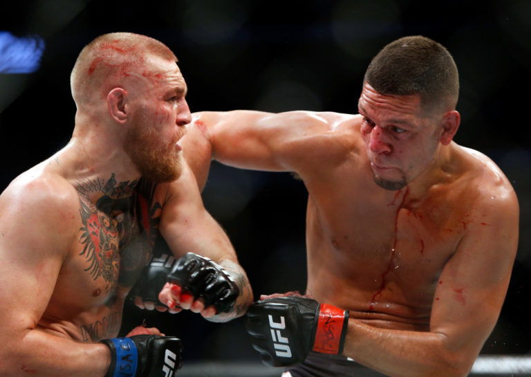 Conor McGregor (L) and Nate Diaz battle during their welterweight rematch at the UFC 202