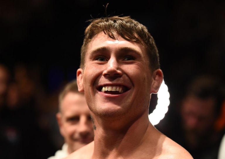 Darren Till smiles before entering the UFC octagon