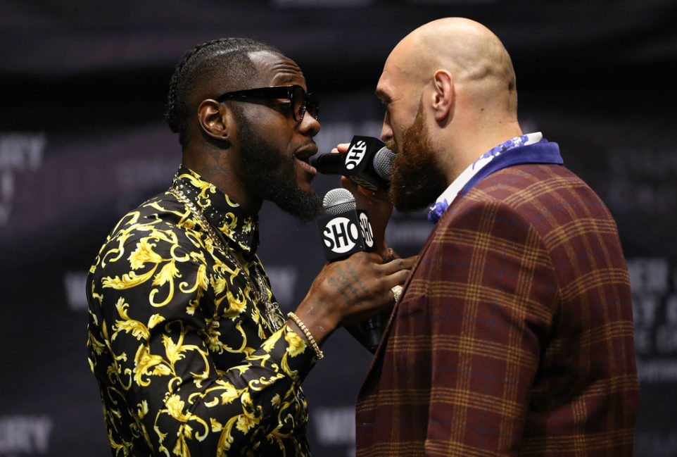 Professional boxers Deontay Wilder (L) and Tyson Fury speak onstage during their press conference