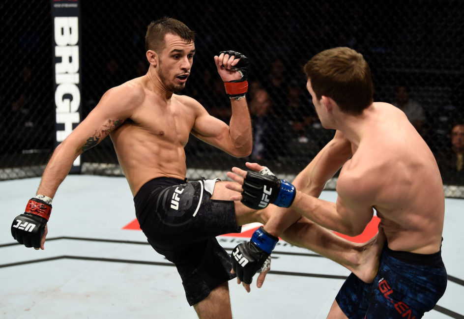 (L-R) Myles Jury kicks the body of Rick Glenn in their featherweight bout during the UFC 219 event inside T-Mobile Arena on December 30, 2017 in Las Vegas, Nevada. (Dec. 29, 2017 - Source: Jeff Bottari/Zuffa LLC/Zuffa LLC)