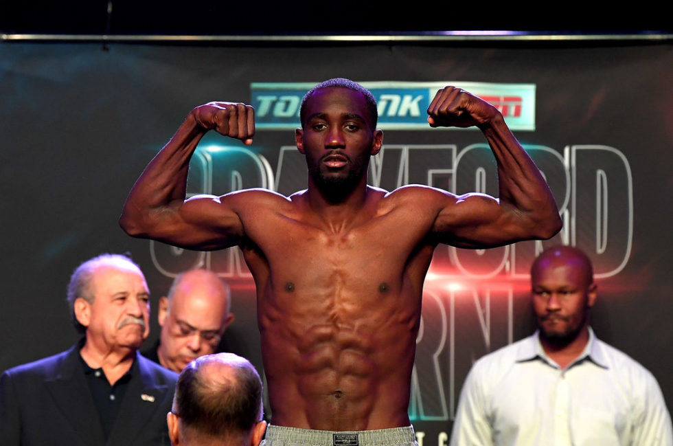 Terence Crawford poses on the scale during his official weigh-in at MGM Grand Garden Arena