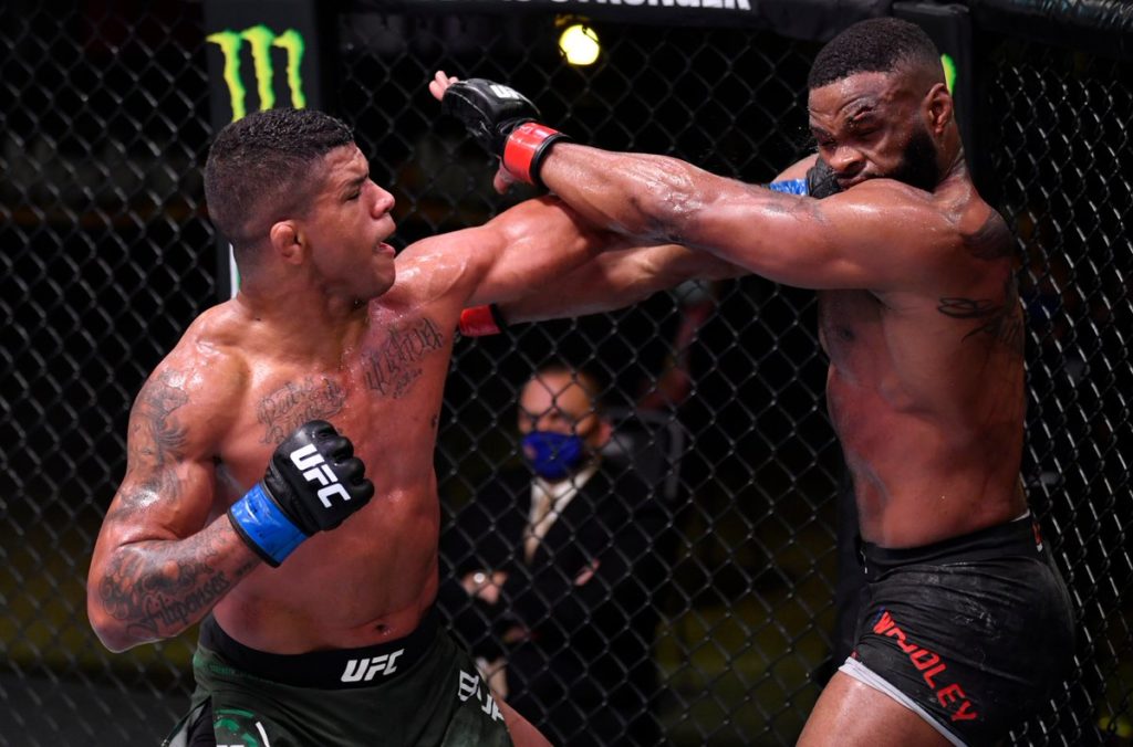 Gilbert Burns hits Tyron Woodley with a left hook