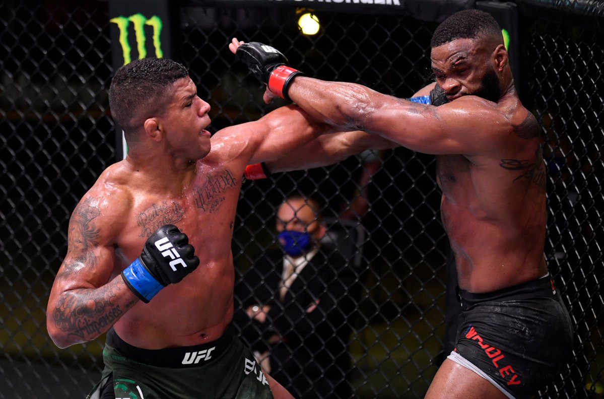 Gilbert Burns hits Tyron Woodley with a left hook