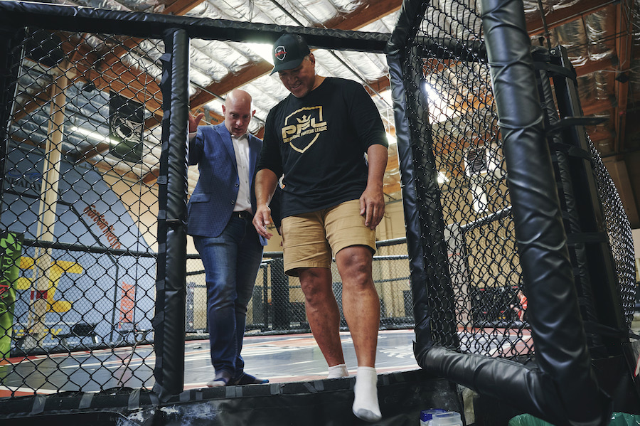 Loren Mack and Ray Sefo talk while exiting a cage
